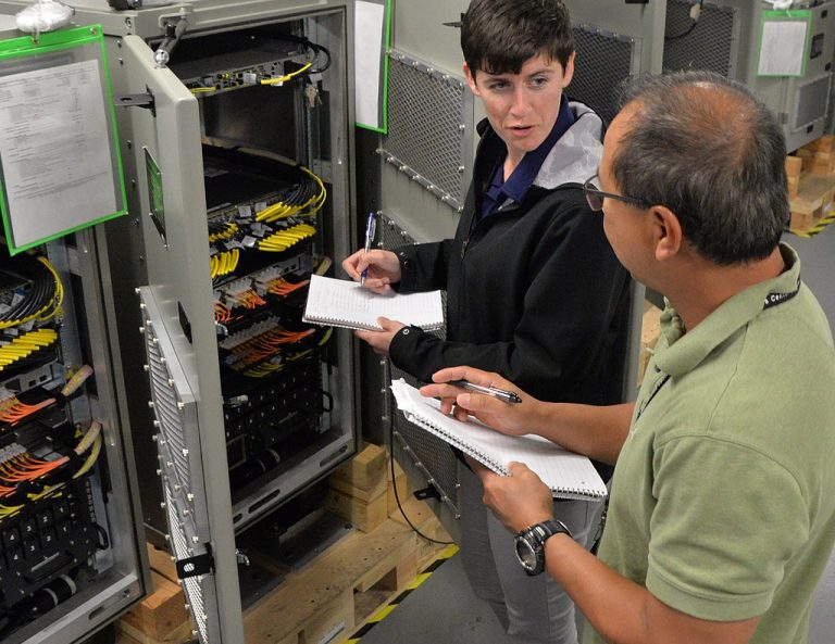 Space and Naval Warfare Systems Center Pacific (SPAWAR) Pre-Installation Test and Check Out (PITCO) technicians Diana Burnside and Arnel Franswells perform acceptance testing on Consolidated Afloat Ships Network Enterprise Services (CANES)