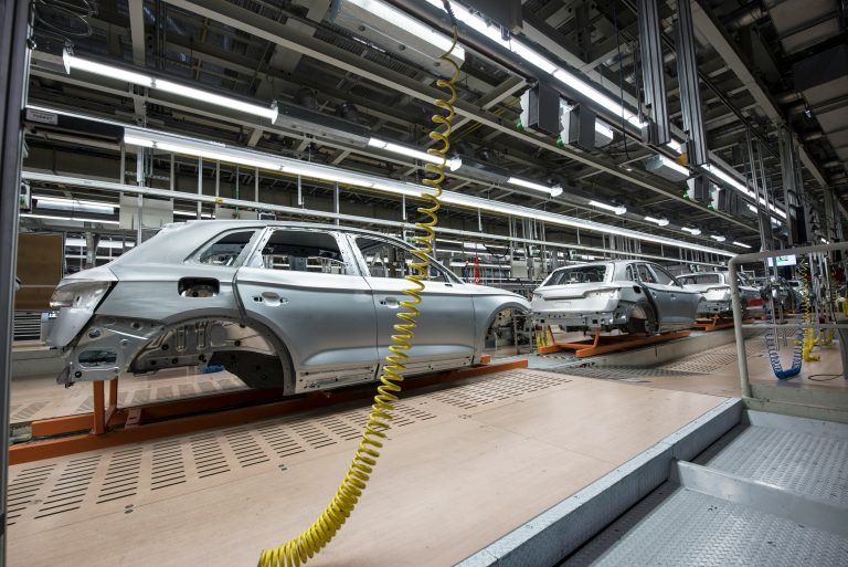 Cars being assembled in an automobile manufacturing assembly line